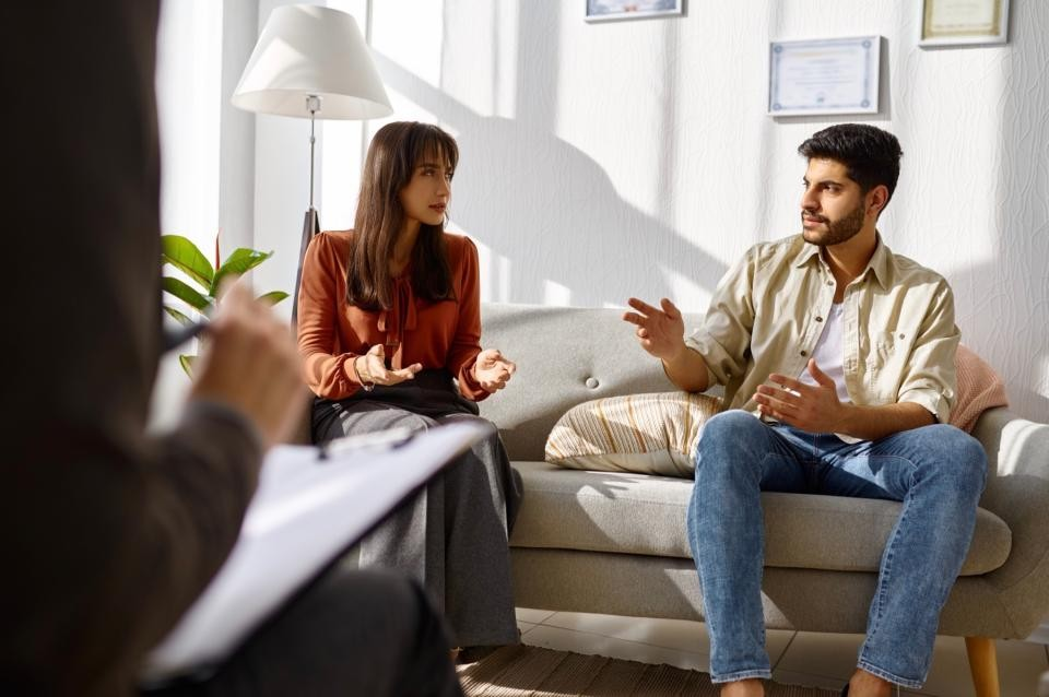 Coach in session with a couple sitting on a sofa