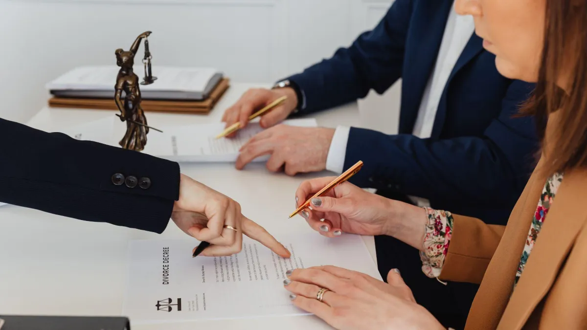 Couple reviewing a divorce decree document with a lawyer